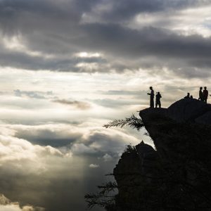 many cloud on sunrise with silhouette people on top of mountain